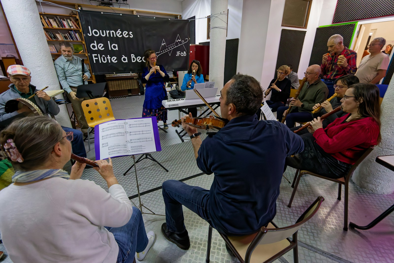 Adults playing musical instruments in a flute workshop.